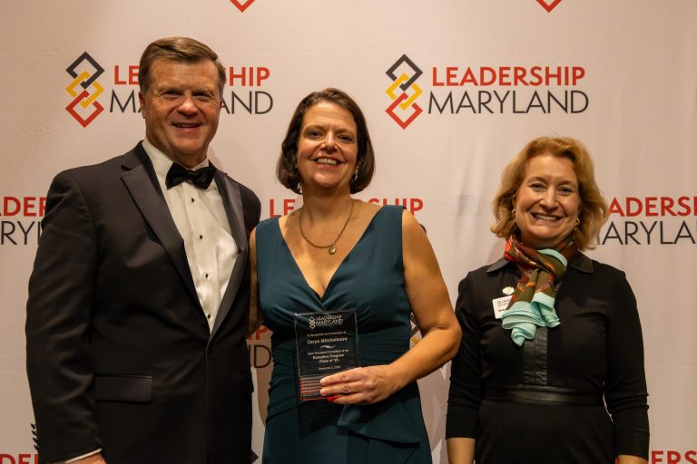 Dr. Carys Mitchelmore in the center. A man and woman representing Leadership Maryland are at her sides.