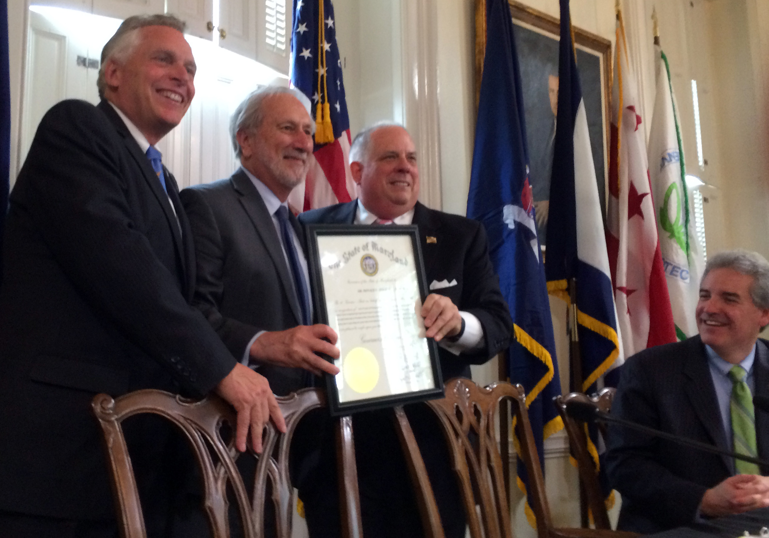 Gov. Larry Hogan presents UMCES President Don Boesch with a Maryland governor's citation while Virginia Gov. Terry McAuliffe (far left) looks on.